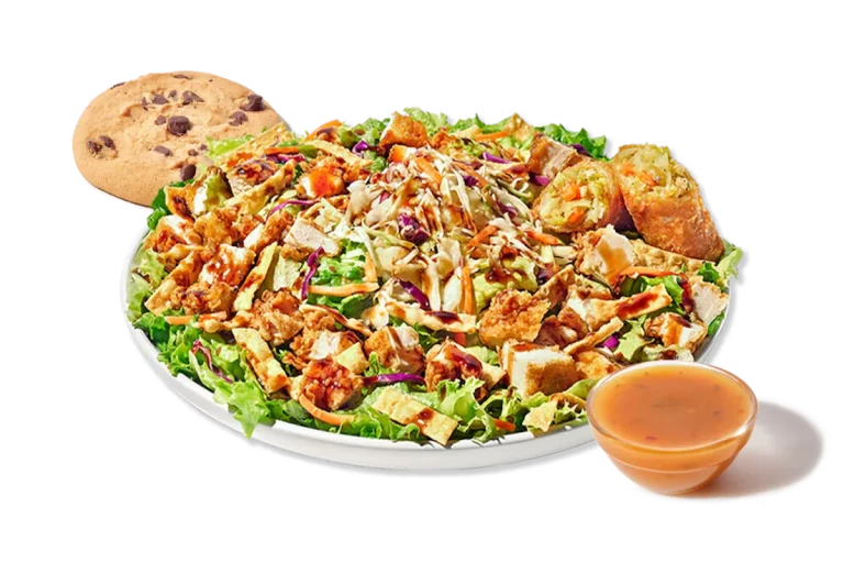 Zaxby's Asian Zensation Zalad™ Boxed Lunch, featuring hand-breaded chicken tenders on a bed of mixed greens, red cabbage, carrots, and wonton strips, topped with Asian slaw and drizzled with honey sesame Teriyaki glaze.