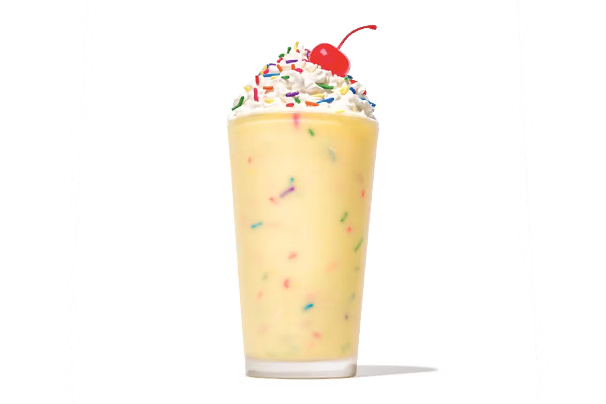 Zaxby's Birthday Cake Milkshake, a creamy milkshake topped with whipped cream, sprinkles, and a sweet birthday cake flavor.