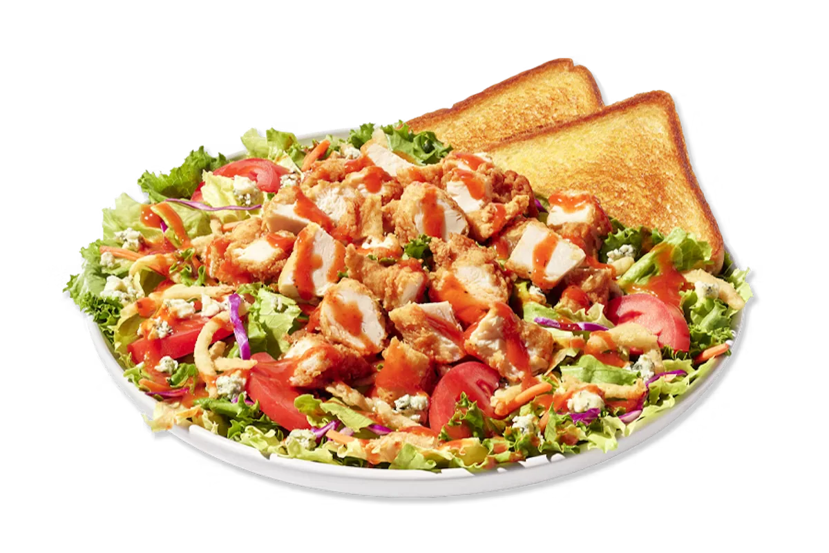Zaxby’s Blue Zalad featuring hand-breaded chicken or grilled chicken, mixed greens, Roma tomatoes, blue cheese crumbles, and fried onion strips.