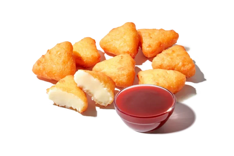 Zaxby's Fried Cheesecake Bites with Strawberry Sauce, featuring crispy, golden cheesecake bites served with a sweet strawberry sauce for dipping.