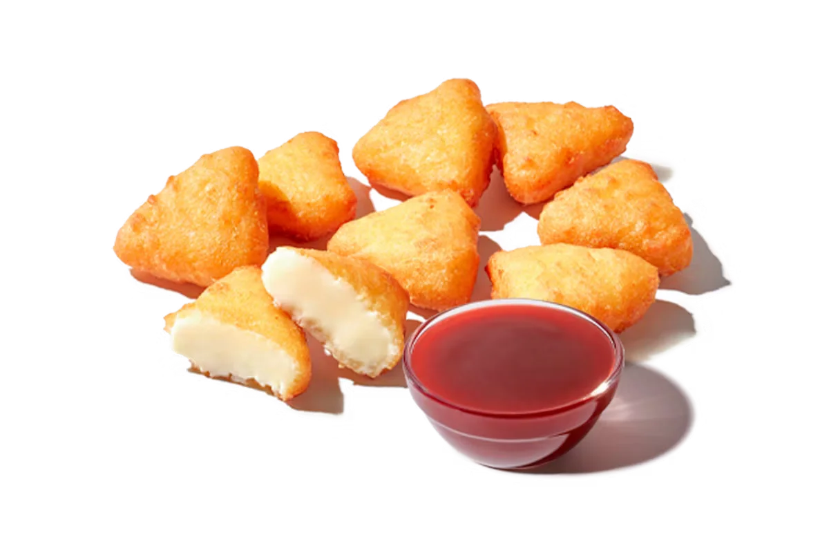 Zaxby's Fried Cheesecake Bites with Strawberry Sauce, featuring crispy, golden cheesecake bites served with a sweet strawberry sauce for dipping.