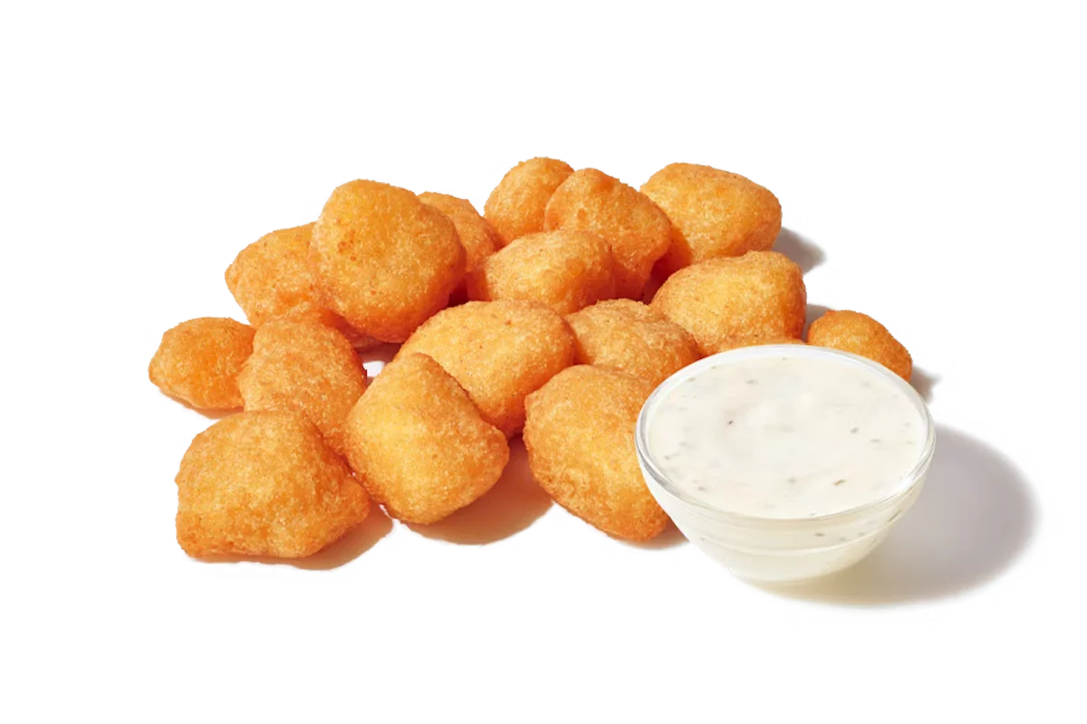 Zaxby's Fried White Cheddar Bites, featuring crispy, batter-dipped white cheddar cheese pieces served with ranch dipping sauce.