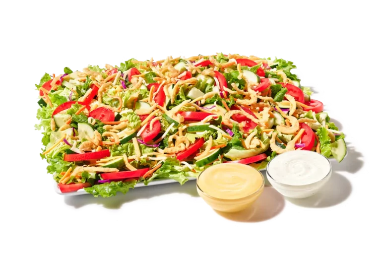 A fresh Zaxby’s Garden Zalad® Platter with mixed greens, cucumbers, grape tomatoes, shredded cheese, and crunchy fried onions.