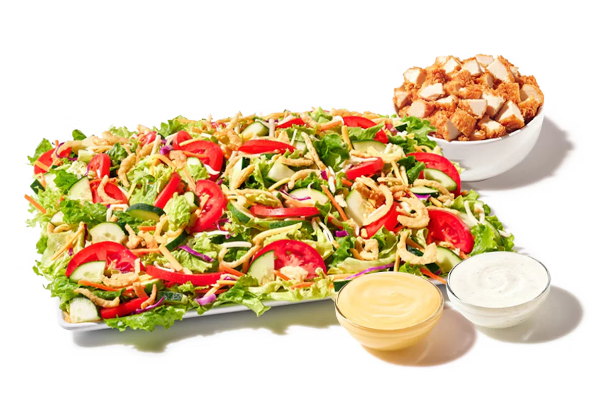 Zaxby’s House Zalad® Platter served with hand-breaded Chicken Fingerz™, mixed greens, cucumbers, tomatoes, shredded cheese, and crispy fried onions.