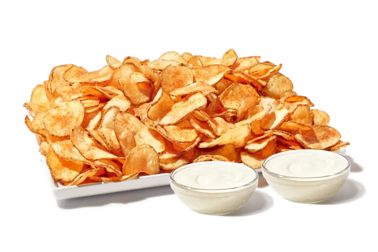Zaxby's Tater Chips Platter, featuring a large serving of crispy, seasoned fried potato chips served with dipping sauces.
