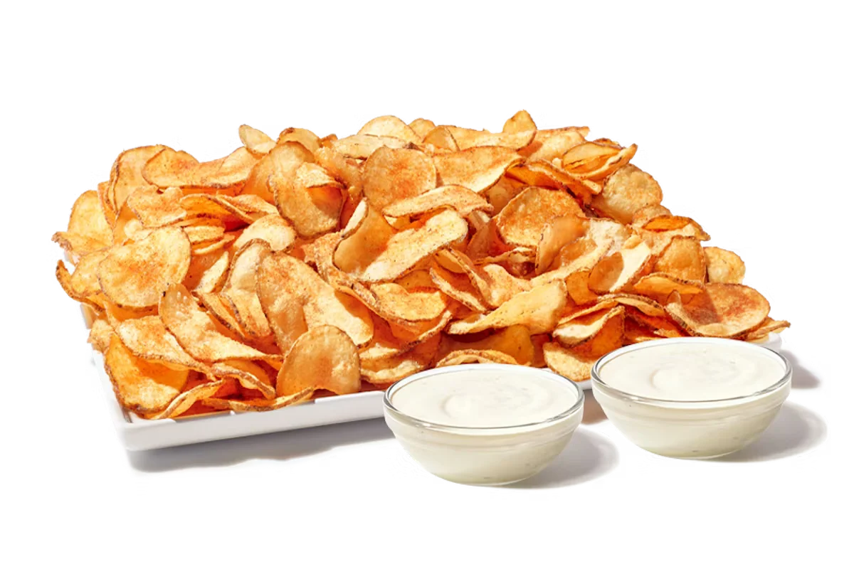 Zaxby's Tater Chips Platter, featuring a large serving of crispy, seasoned fried potato chips served with dipping sauces.
