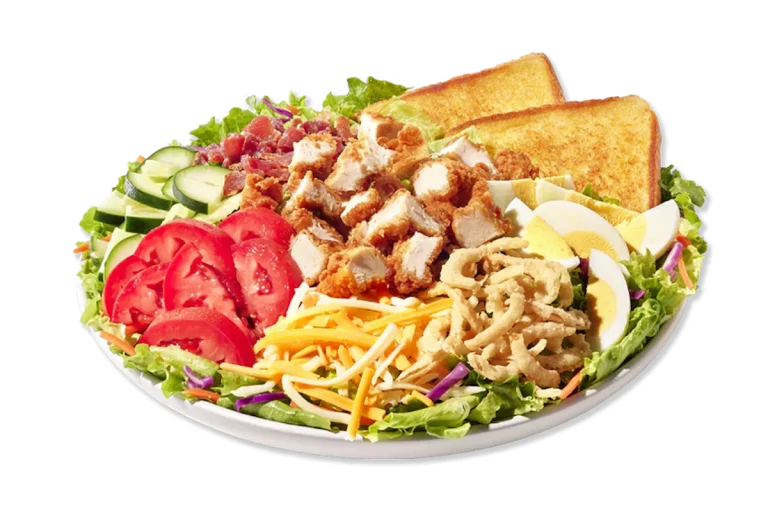 Zaxby’s Cobb Zalad topped with grilled or fried chicken, hard-boiled egg, bacon, cheese, tomatoes, and crispy fried onions on a bed of fresh greens.