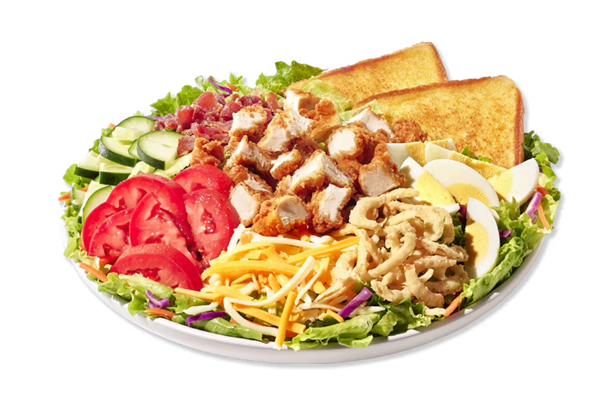 Zaxby’s Cobb Zalad topped with grilled or fried chicken, hard-boiled egg, bacon, cheese, tomatoes, and crispy fried onions on a bed of fresh greens.