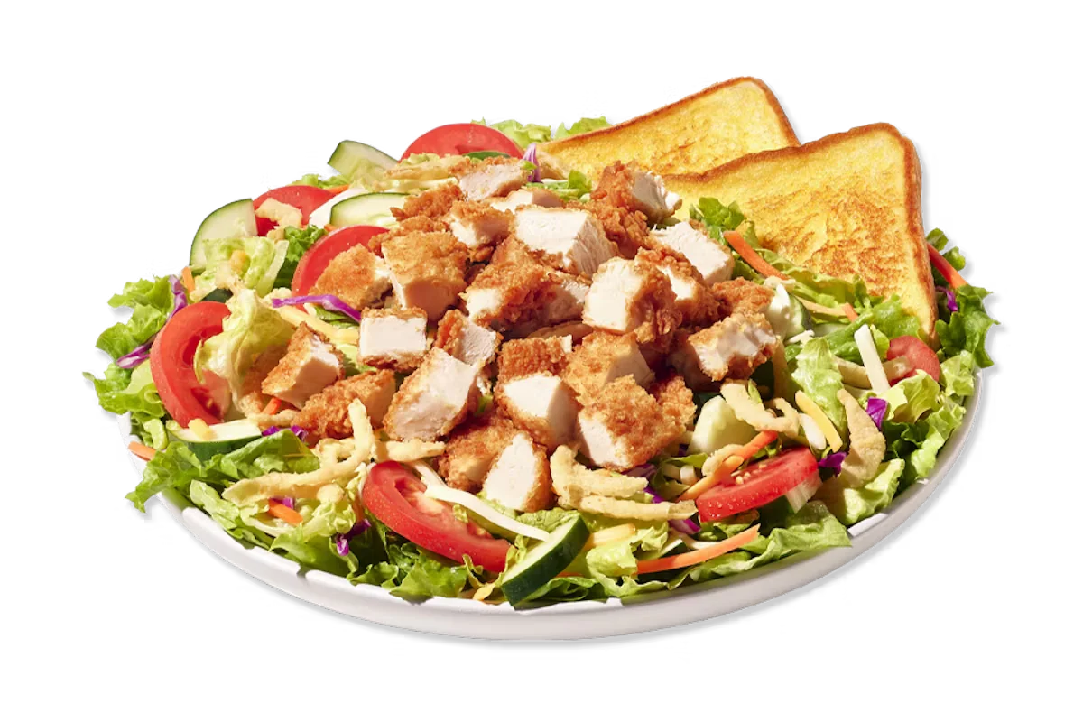 Zaxby’s House Zalad® with grilled or fried chicken on mixed greens, topped with tomatoes, cucumbers, cheese, and fried onions.