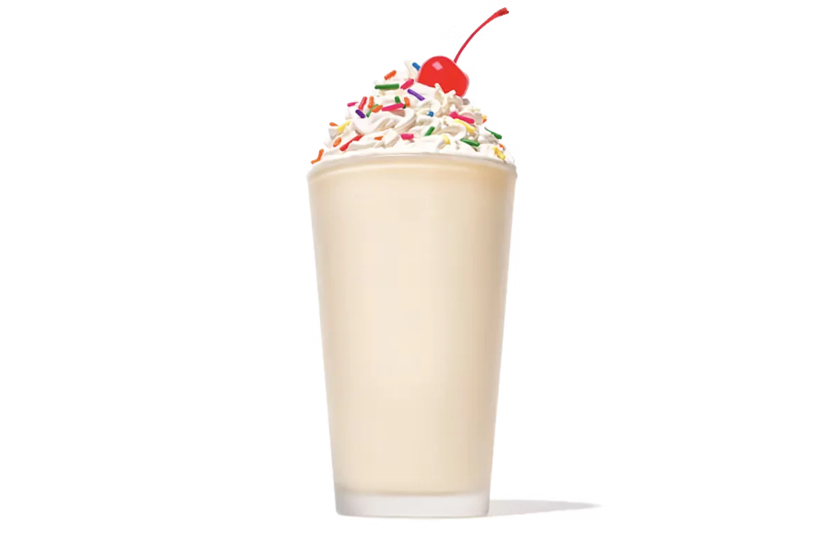 Zaxby's Vanilla Milkshake, a creamy milkshake blended with rich vanilla flavor, topped with whipped cream and a vanilla drizzle.