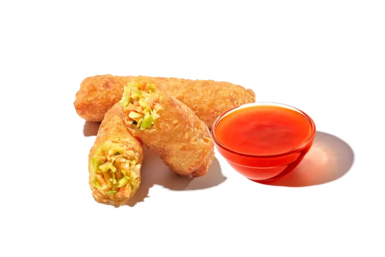 Zaxby's Veggie Egg Rolls, featuring crispy egg rolls filled with seasoned vegetables, served with dipping sauce.